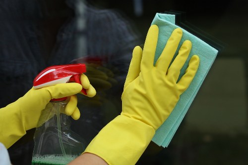 Professional cleaning team working on hardwood floors